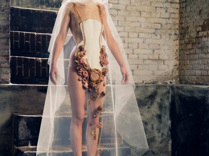 Her dreamworld whispers around her slender being